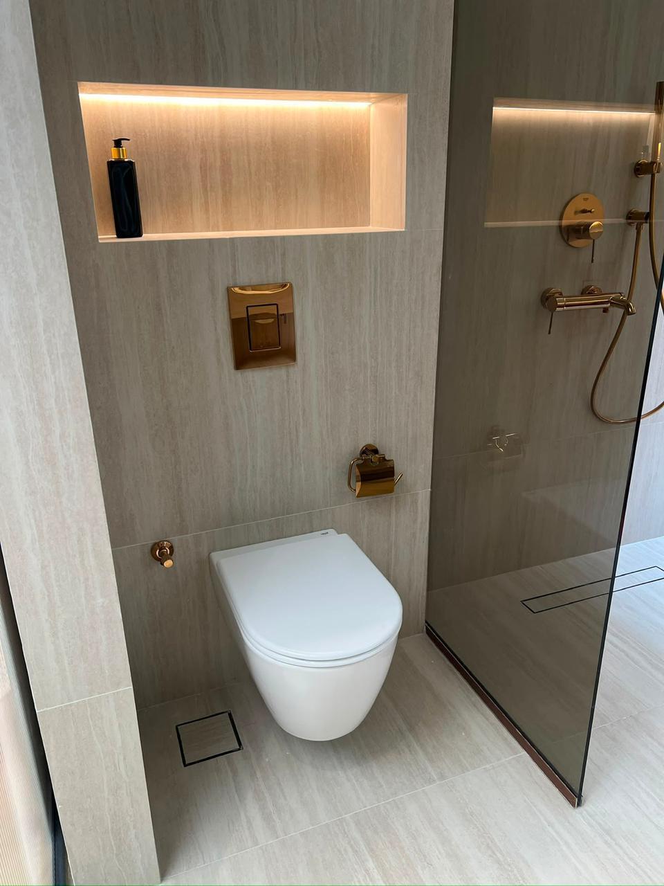 Completed bathroom with bronze fittings and tiled finishes